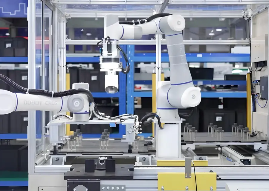 Two Dobot cobots, one a CR16, working in an automated assembly cell