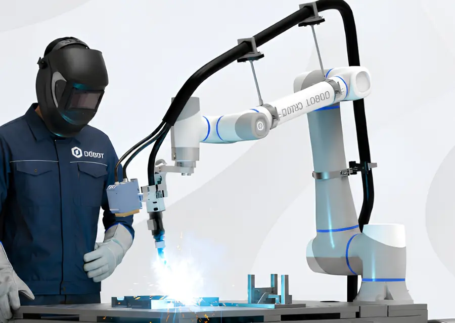 Welder working alongside a Dobot welding cobot