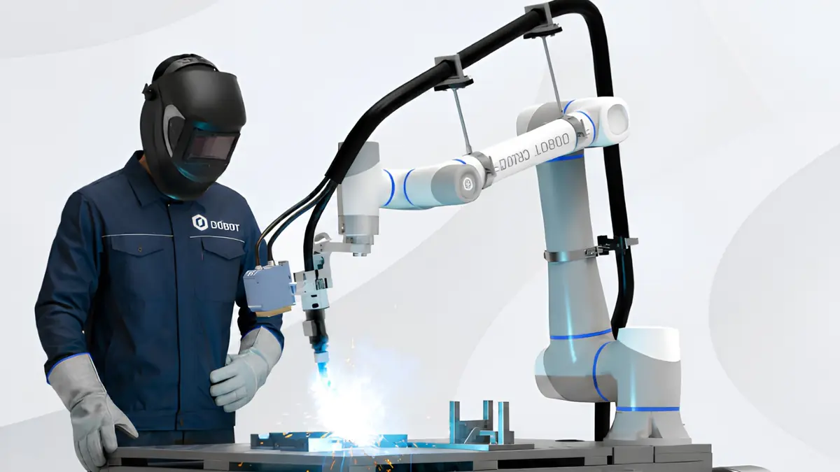 Welder working alongside a Dobot collaborative welding robot