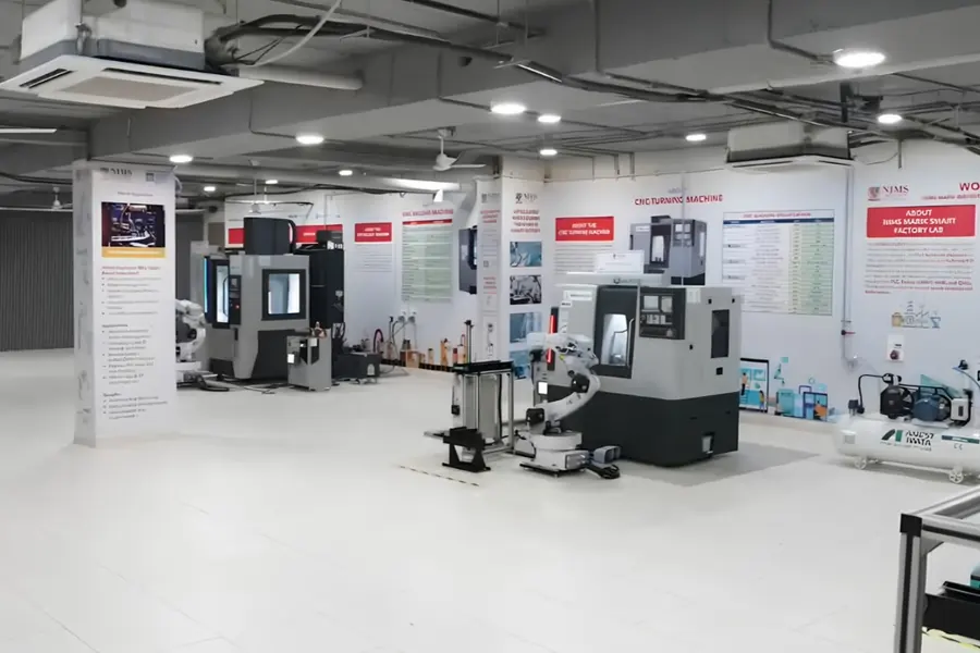 Smart factory lab set up by Ausweg with CNC machines, a robot cell and training stations