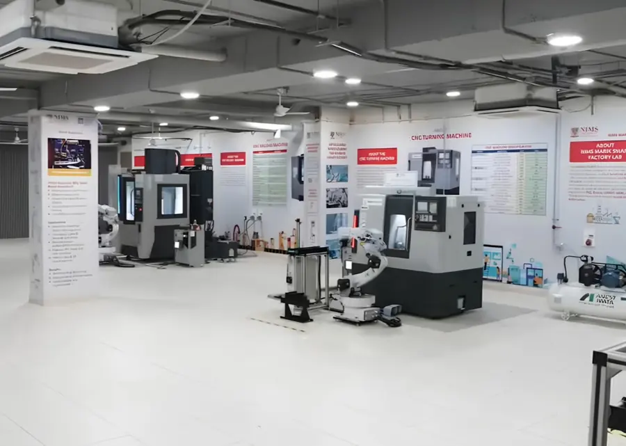 Smart factory lab set up by Ausweg with CNC machines and a robot cell